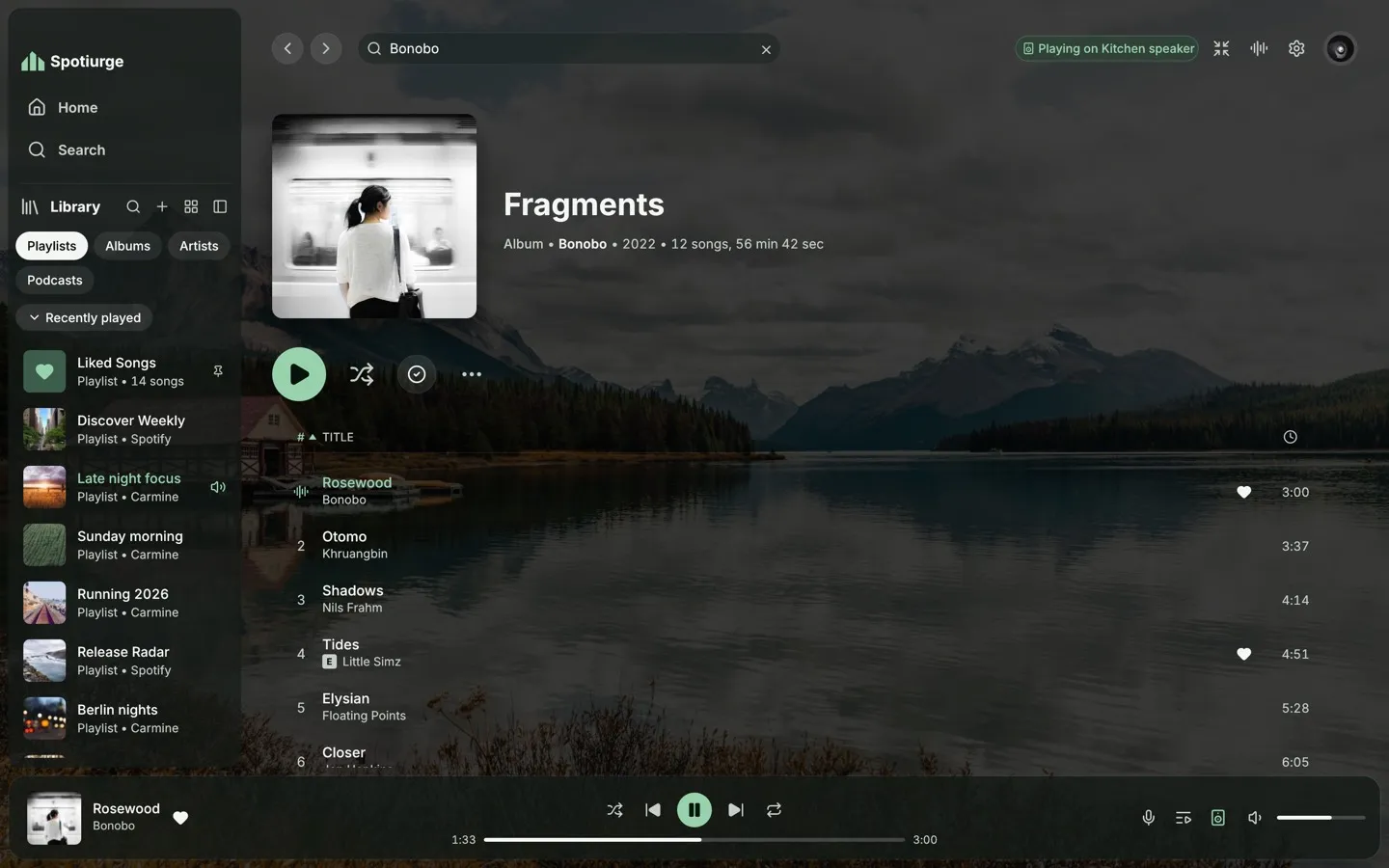 Spotiurge playing an album, its track list floating over a dimmed mountain-lake photo